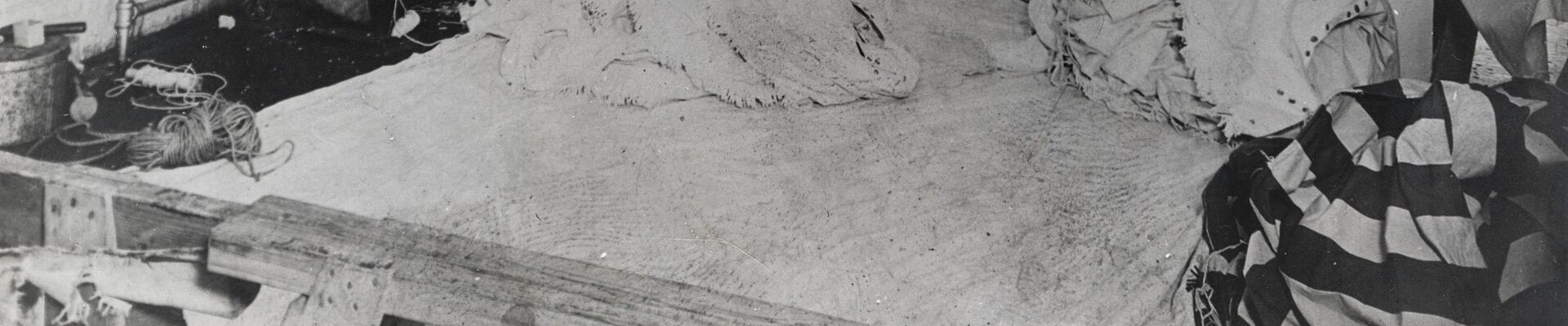 Striped awning canvas folded on a workroom floor in 1910