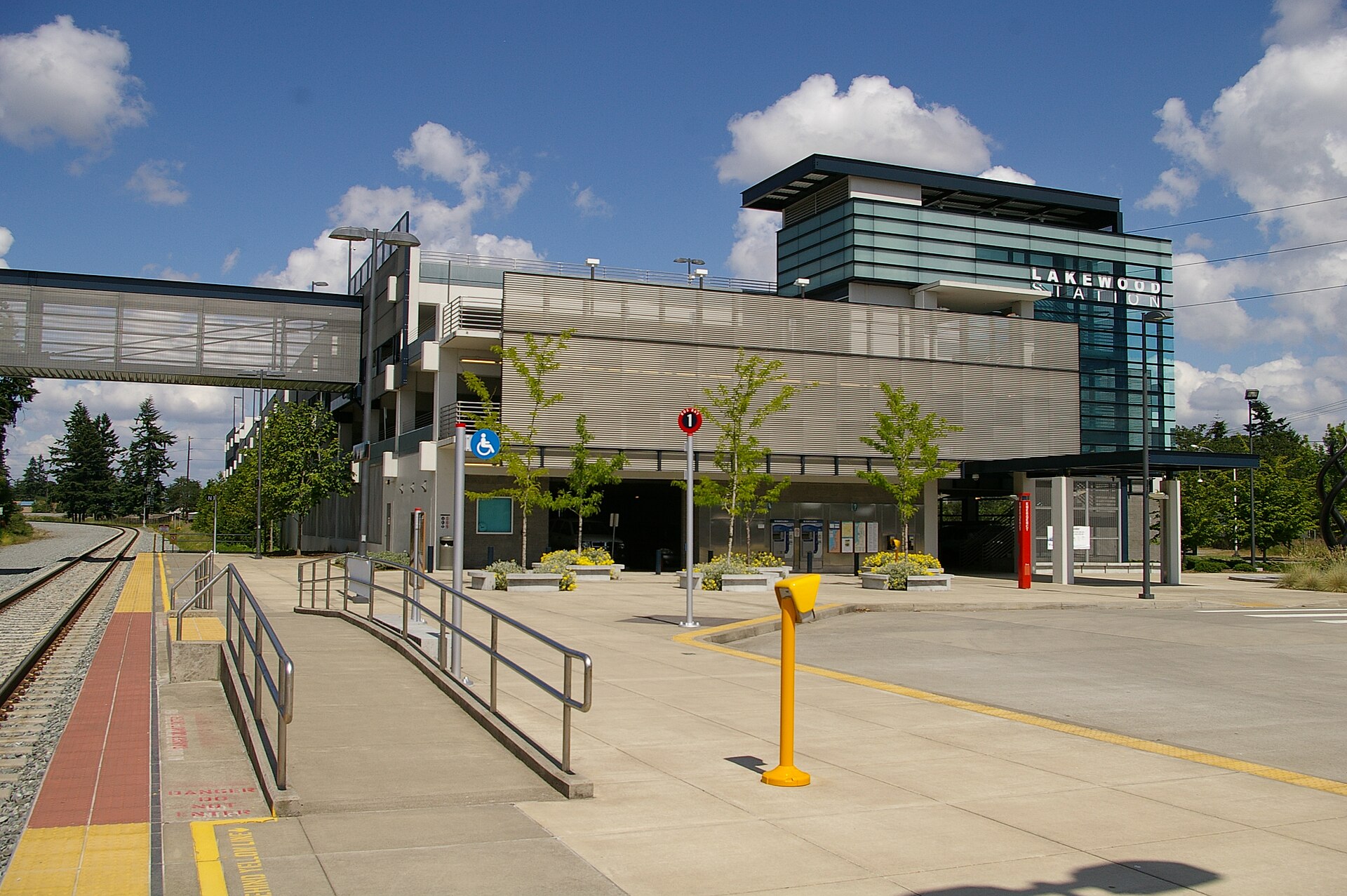 Lakewood Station, a modern transit building with trees and a platform under a blue sky